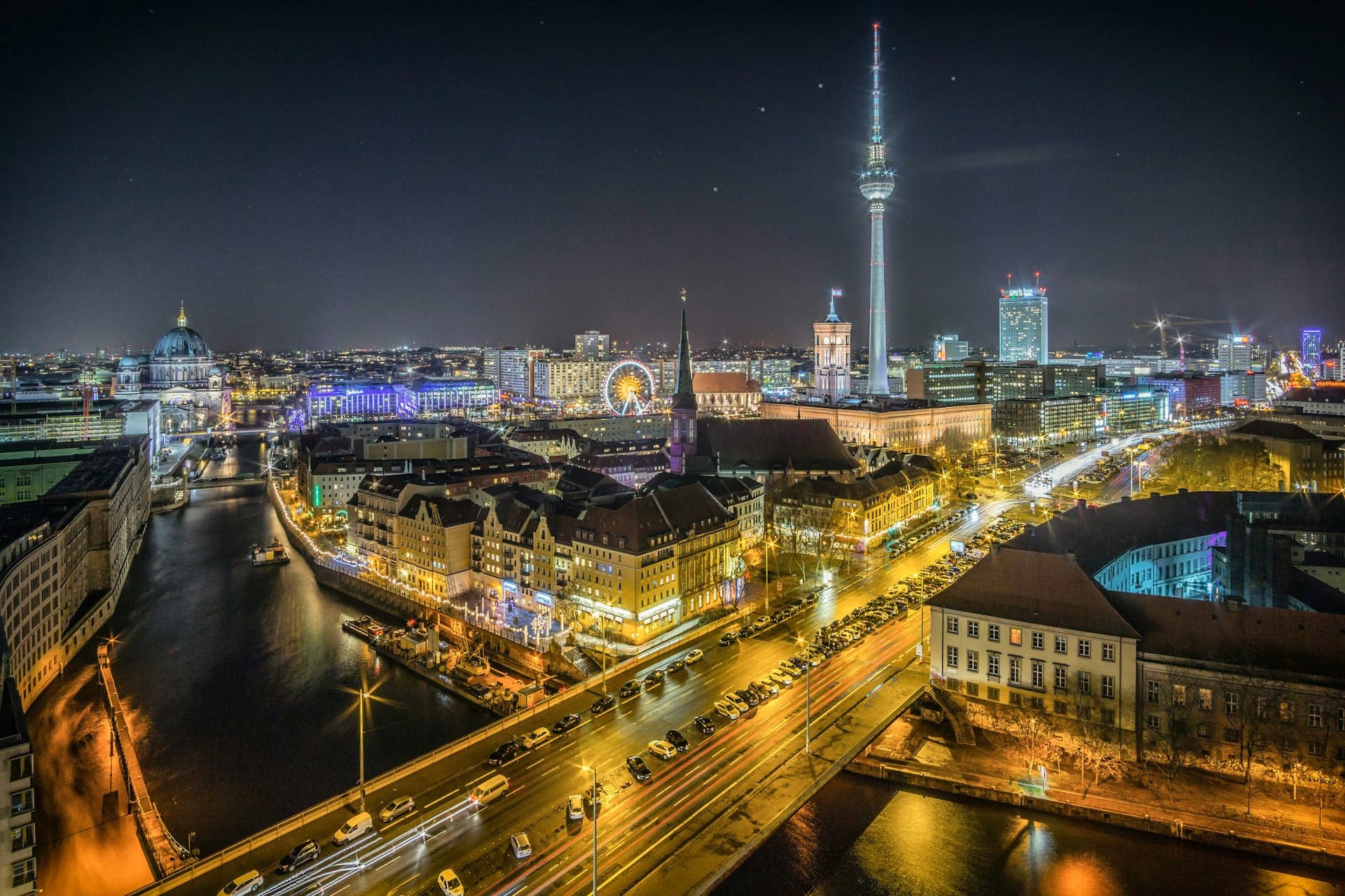 City skyline at night with an iconic TV tower, representing Atlas TV's global streaming coverage